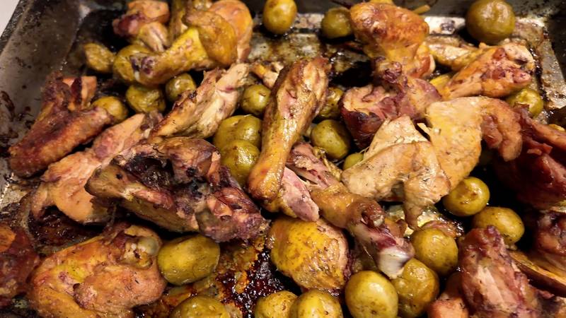 A tray of smoked chicken pieces with small roast potatoes