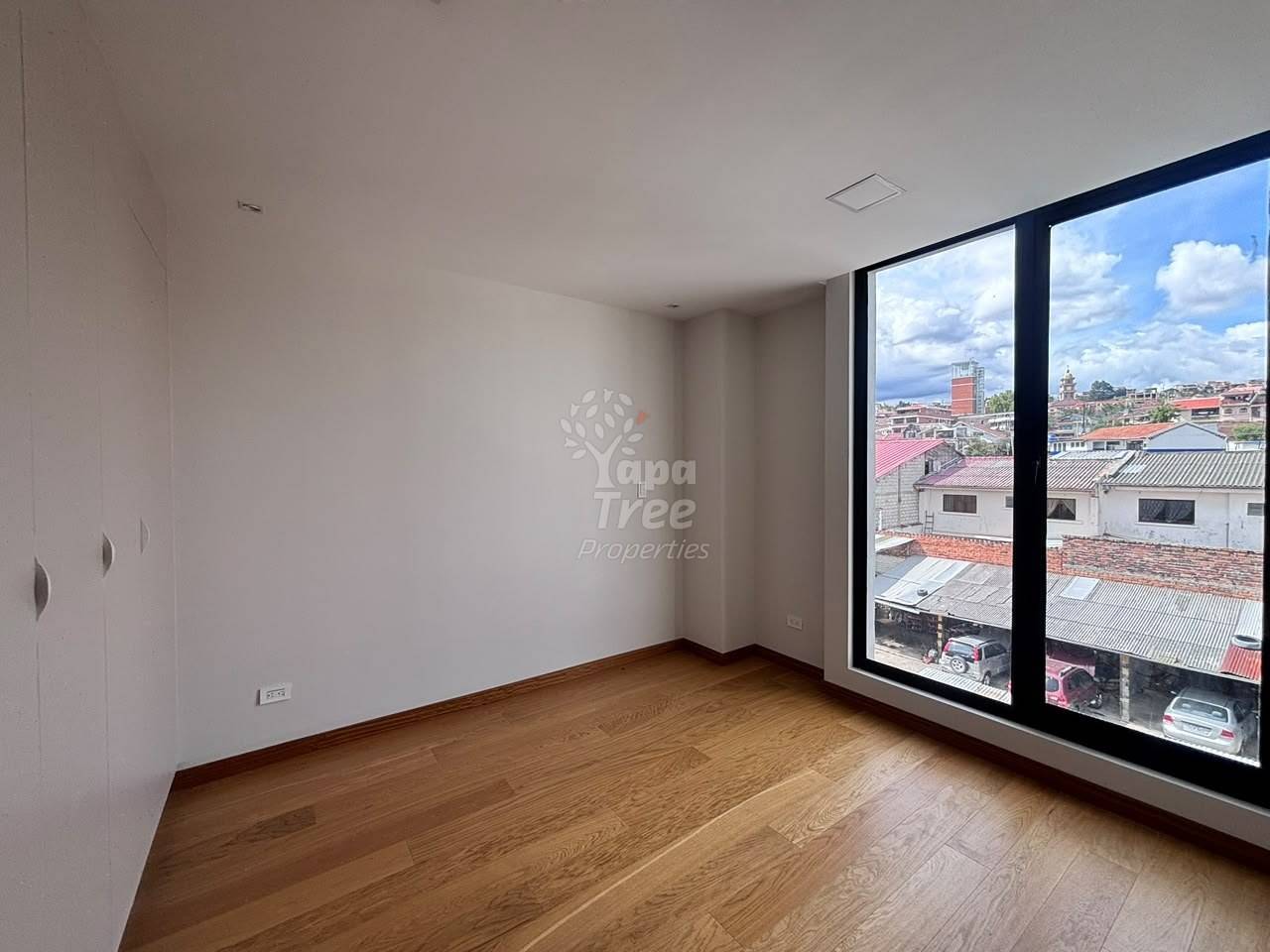 photo of a bedroom with a floor-to-ceiling window