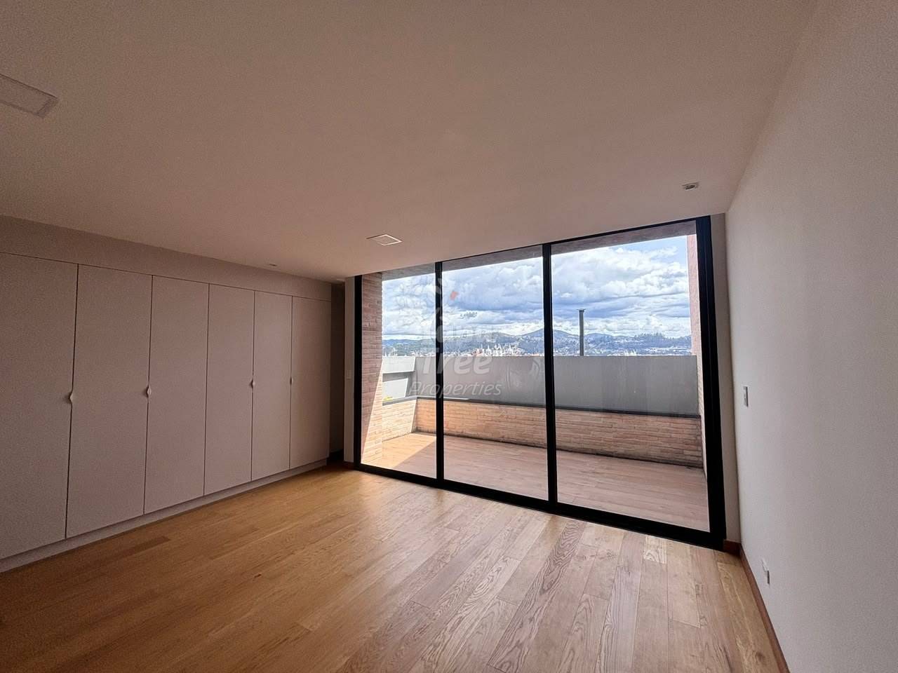photo of a bedroom with built-in wardrobes and a door to the balcony