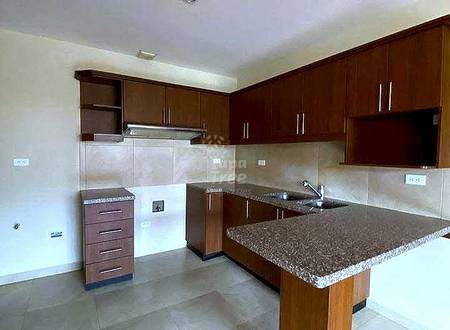 Cocina with dark wood cabinetry, granite countertops, central island, beige tile backsplash, and ceramic floor.