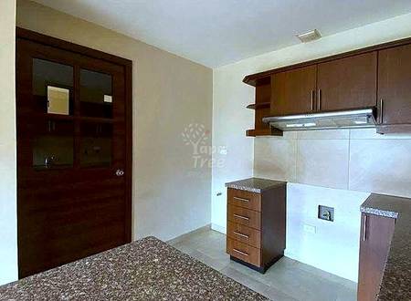 Kitchen with dark wood cabinets, light granite countertops, beige tile backsplash, and light tile flooring.
