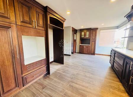 Kitchen with wood-grain tile flooring, dark wood cabinetry, recessed ceiling lights, window with natural light, and built-in shelving units.