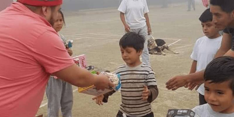 Mauricio handing out toys